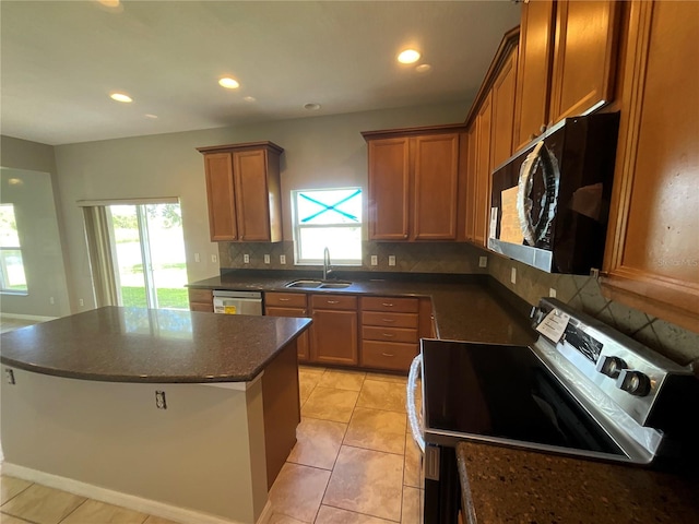 kitchen with light tile patterned floors, sink, backsplash, dishwasher, and electric range