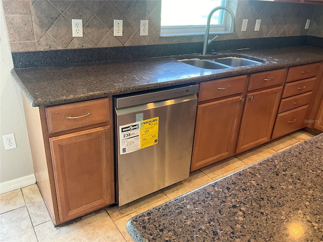 kitchen with light tile patterned flooring, sink, tasteful backsplash, and stainless steel dishwasher