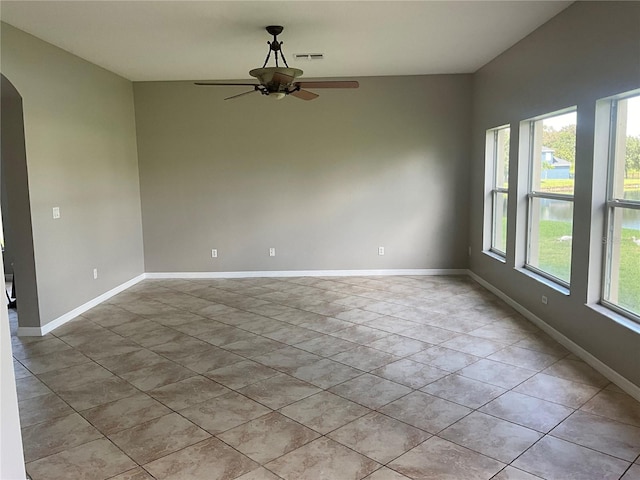 spare room with light tile patterned floors and ceiling fan