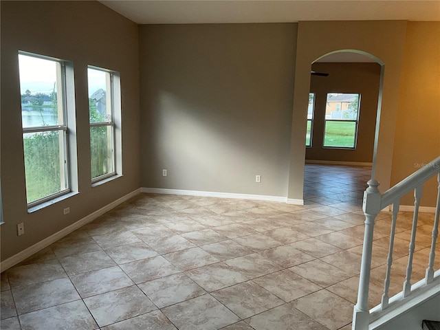 tiled spare room with a wealth of natural light