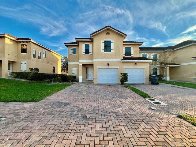 view of front of property featuring a garage and a front lawn