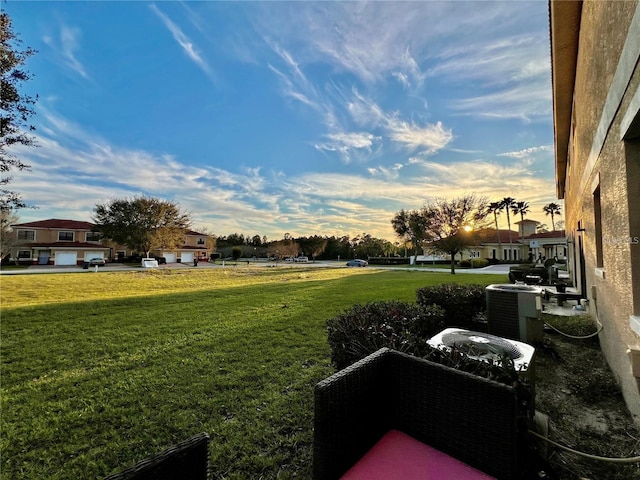 yard at dusk featuring cooling unit