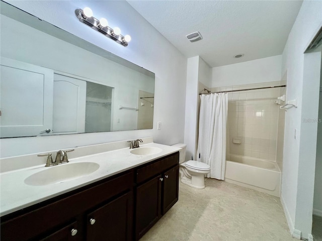 full bathroom featuring shower / bath combination with curtain, a textured ceiling, vanity, and toilet