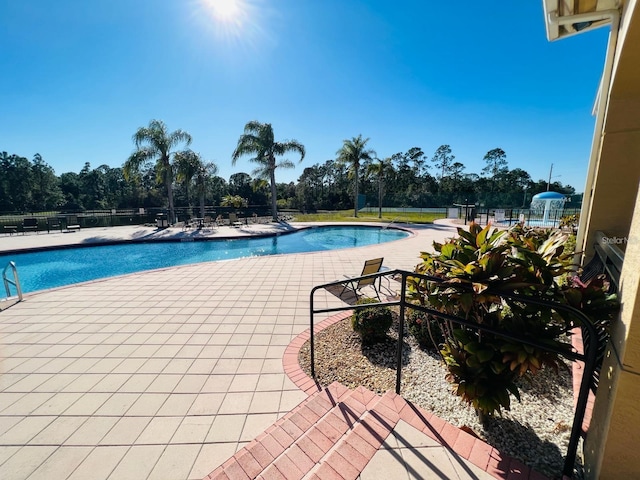 view of swimming pool with a patio