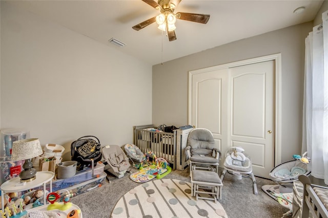 playroom featuring ceiling fan and carpet