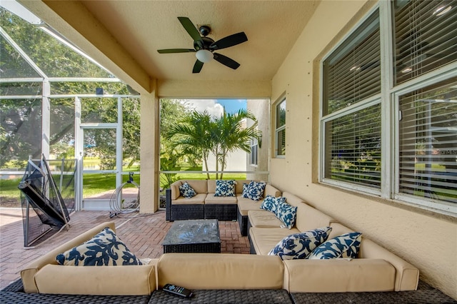 view of patio with glass enclosure, ceiling fan, and outdoor lounge area