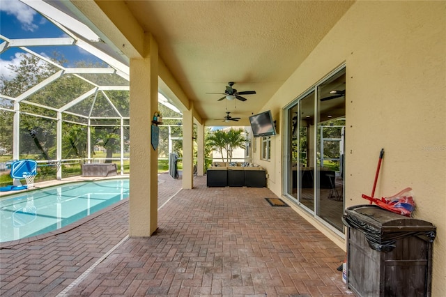 view of patio with ceiling fan and a lanai