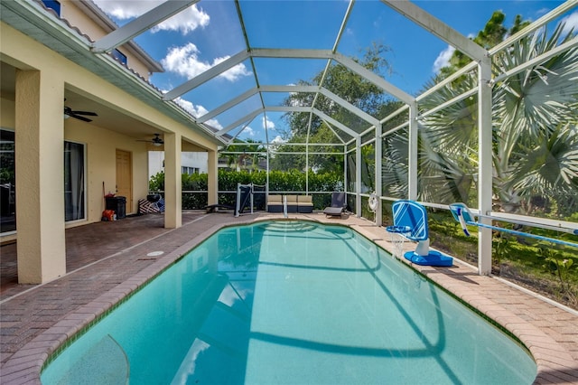 view of swimming pool featuring a lanai, ceiling fan, and a patio area