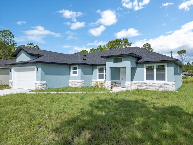 view of front of house featuring a garage and a front lawn