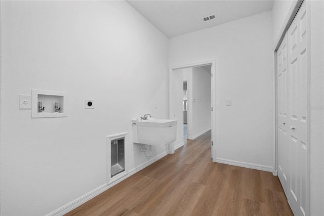 laundry area with washer hookup, electric dryer hookup, and light hardwood / wood-style floors