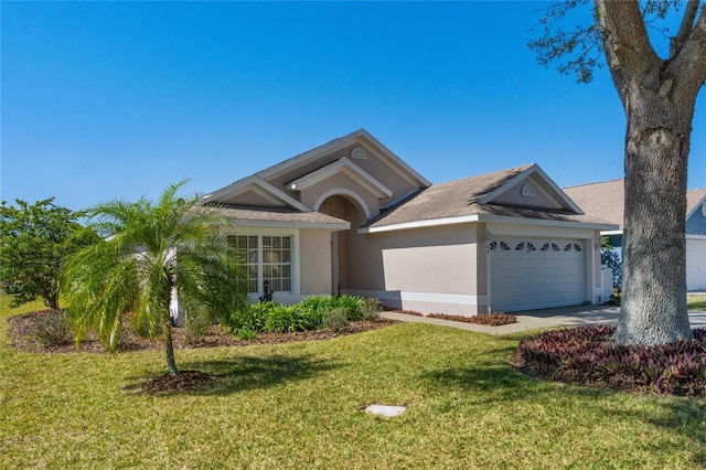 ranch-style house featuring a garage and a front yard