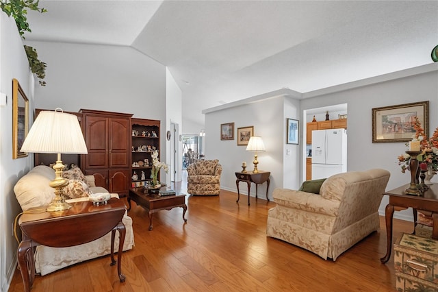 living room featuring light hardwood / wood-style floors and lofted ceiling