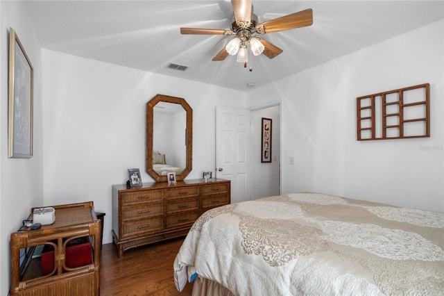 bedroom with dark hardwood / wood-style floors and ceiling fan