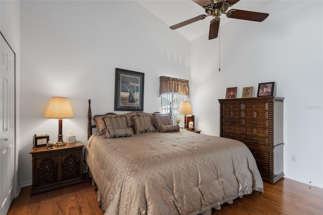 bedroom featuring hardwood / wood-style flooring, high vaulted ceiling, a closet, and ceiling fan