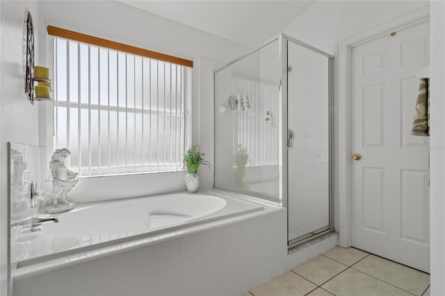 bathroom featuring tile patterned flooring and shower with separate bathtub