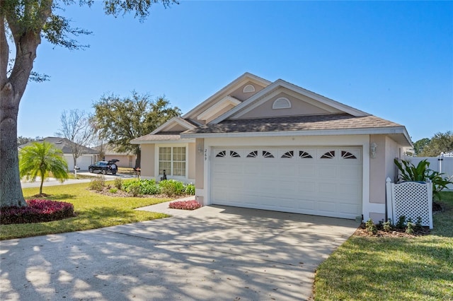 view of front of property with a front lawn and a garage