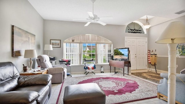 tiled living room featuring a textured ceiling and ceiling fan