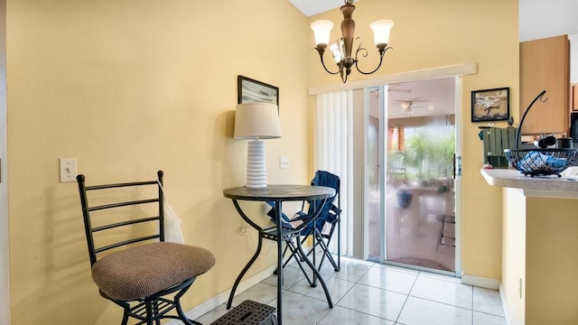 tiled dining room featuring a notable chandelier