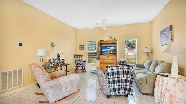 tiled living room with ceiling fan