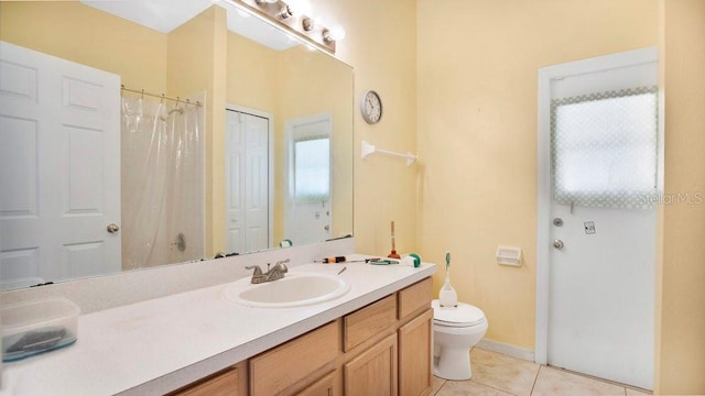 bathroom featuring vanity, tile patterned flooring, and toilet