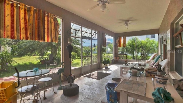 sunroom featuring ceiling fan