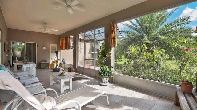 sunroom / solarium featuring ceiling fan