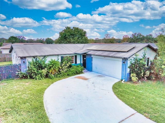 ranch-style home featuring a front lawn and a garage