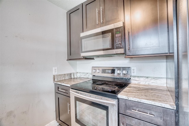 kitchen featuring stainless steel appliances and a textured ceiling