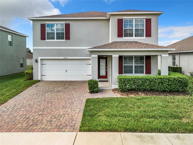 view of front facade featuring a front yard and a garage