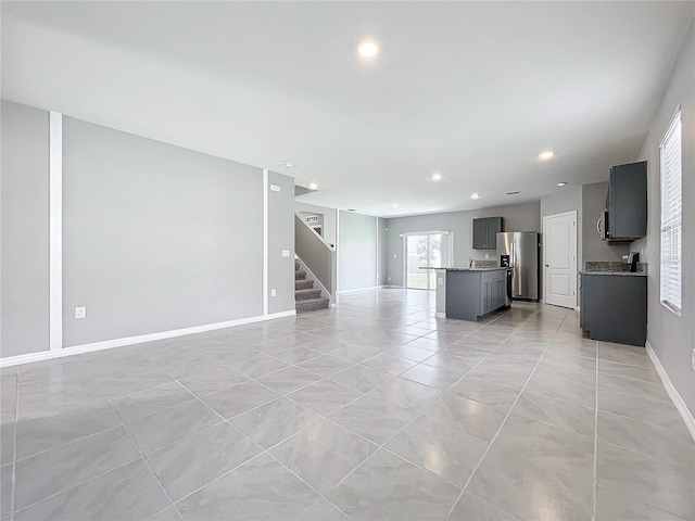 unfurnished living room with light tile patterned floors