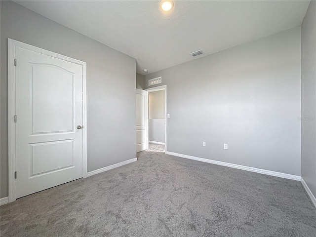 unfurnished bedroom featuring a textured ceiling and carpet flooring