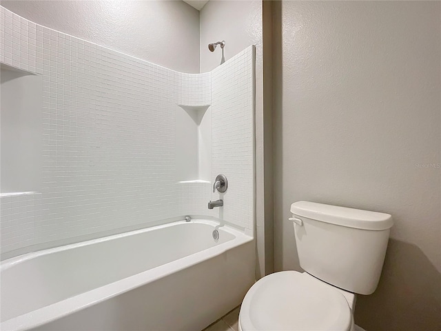 bathroom featuring tub / shower combination and toilet