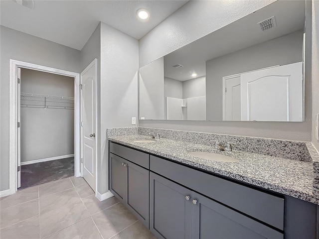 bathroom featuring vanity and tile patterned flooring