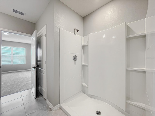 bathroom featuring a shower and tile patterned floors