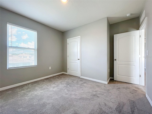 unfurnished bedroom featuring light colored carpet