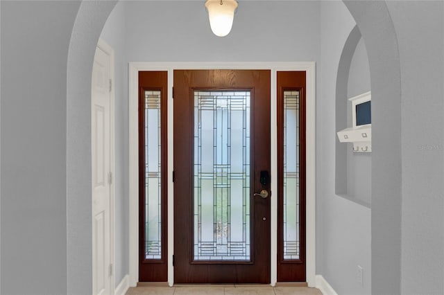 tiled entryway with a healthy amount of sunlight