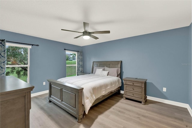 bedroom with ceiling fan and light hardwood / wood-style flooring