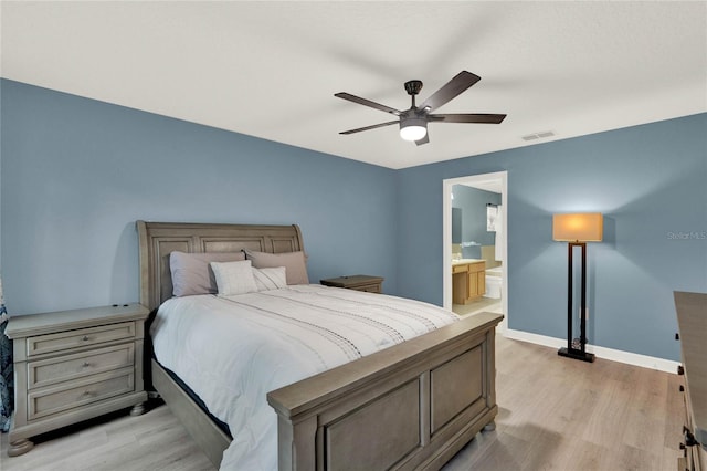 bedroom with light hardwood / wood-style flooring, ensuite bathroom, and ceiling fan