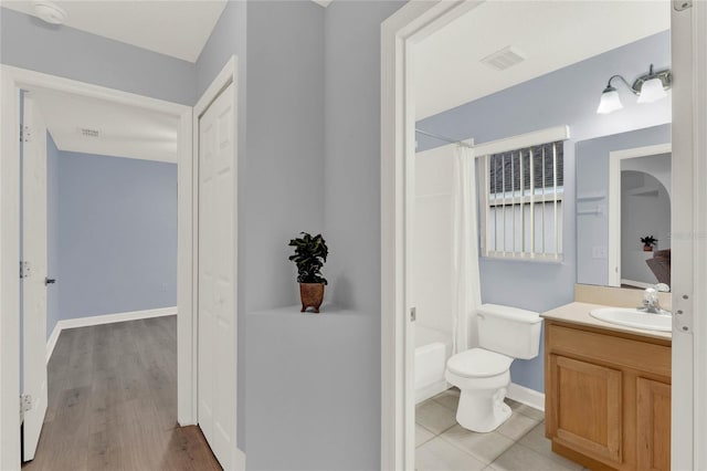 full bathroom with vanity, toilet, wood-type flooring, and shower / tub combo with curtain