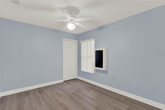 spare room with light hardwood / wood-style floors and ceiling fan