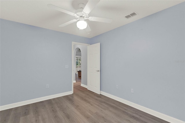 empty room featuring ceiling fan and hardwood / wood-style floors