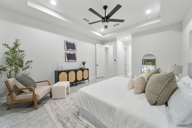 bedroom featuring ceiling fan and a raised ceiling