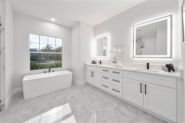 bathroom with a tub to relax in and vanity