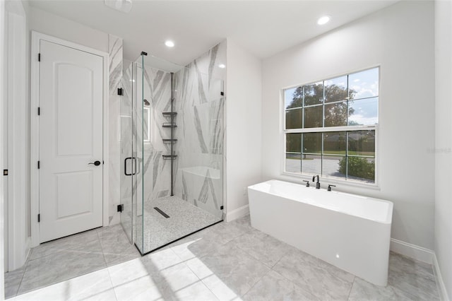 bathroom with separate shower and tub