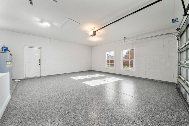 garage featuring a garage door opener and electric water heater