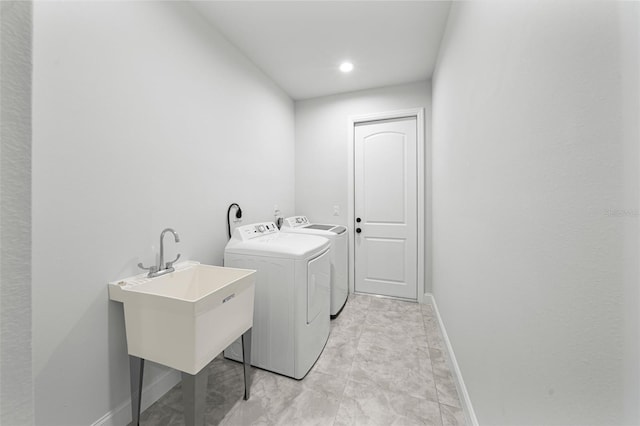 laundry area featuring washing machine and dryer and sink