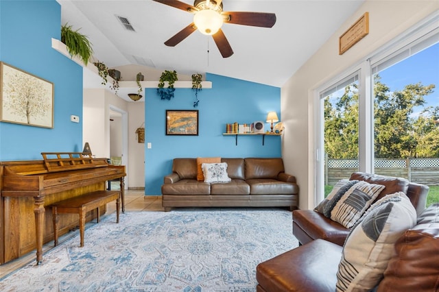 tiled living room with ceiling fan and lofted ceiling