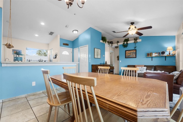 dining space featuring ceiling fan, light tile patterned flooring, and lofted ceiling