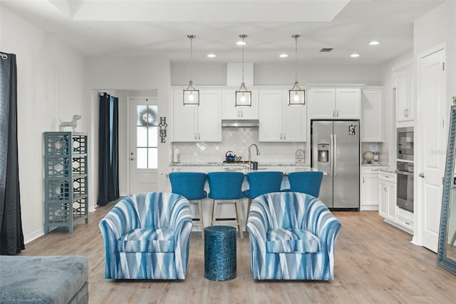 living room featuring light hardwood / wood-style floors and sink