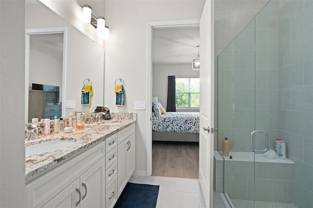 bathroom featuring vanity, an enclosed shower, and tile patterned flooring